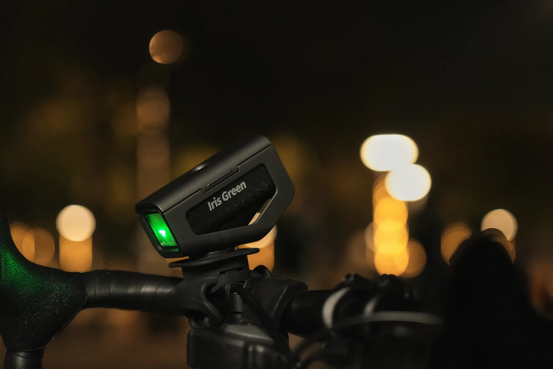 IRISGreen mounted on bicycle handlebars at night