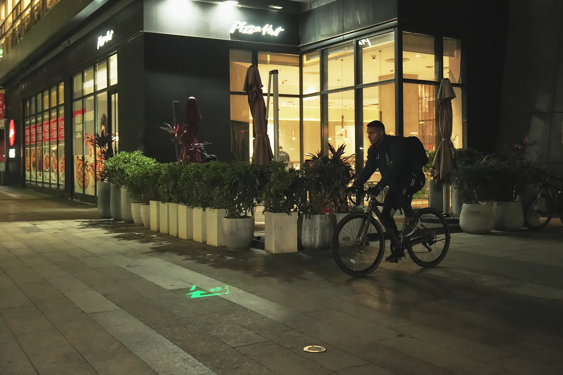 Visible green road projection beside cyclist